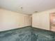 Neutral bedroom featuring green carpet, trim work, and access to ensuite bathroom at 2912 Peachwood Ct, Fort Mill, SC 29715