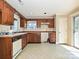 Well-lit kitchen with wooden cabinets, patterned flooring, and plenty of counter space, ready for renovation at 2912 Peachwood Ct, Fort Mill, SC 29715