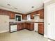 Functional kitchen with wood cabinetry, patterned flooring, and abundant natural light, ready for customization at 2912 Peachwood Ct, Fort Mill, SC 29715
