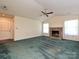 Open living room with a vaulted ceiling, a stone fireplace, a ceiling fan, and large windows offering ample light at 2912 Peachwood Ct, Fort Mill, SC 29715