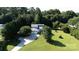 Aerial view of inviting gray home with lush lawn, mature trees, and large driveway at 2949 Glenstone Dr, Rock Hill, SC 29730