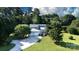 An aerial view of a gray home with a three-car garage on a large lot with mature trees at 2949 Glenstone Dr, Rock Hill, SC 29730