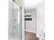 Modern bathroom featuring a glass shower with marble style tile and an arched window at 2949 Glenstone Dr, Rock Hill, SC 29730