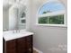 Bathroom vanity with dark cabinets, white countertop, decorative lighting and an arched window at 2949 Glenstone Dr, Rock Hill, SC 29730