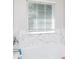 Bright bathroom featuring a white tub with marble style tile and a window with blinds at 2949 Glenstone Dr, Rock Hill, SC 29730