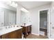 Bathroom with wood floors, double sink vanity with mirrors, white walls, and white trim at 2949 Glenstone Dr, Rock Hill, SC 29730