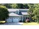 Charming gray home with three-car garage, landscaped yard and inviting front entrance at 2949 Glenstone Dr, Rock Hill, SC 29730