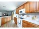 Bright kitchen with cherry cabinets, white appliances and white countertops at 2949 Glenstone Dr, Rock Hill, SC 29730