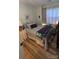 Cozy bedroom featuring wood floors, comfortable bed, and soft natural light at 311 Wilkes Place Dr, Fort Mill, SC 29715