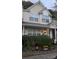 Inviting townhome with a covered porch, manicured bushes, and seasonal decorations at 311 Wilkes Place Dr, Fort Mill, SC 29715