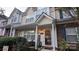 Charming townhome featuring a cozy front porch and well-maintained landscaping at 311 Wilkes Place Dr, Fort Mill, SC 29715