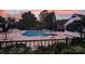 Community pool surrounded by lush landscaping and lounge chairs at 311 Wilkes Place Dr, Fort Mill, SC 29715