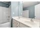 Bathroom showcasing a double sink vanity, white cabinets, large mirror, and a shower/tub combination at 4520 Buck Skin Ct, Fort Mill, SC 29707