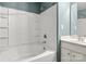 Bright bathroom showcasing a tub with tiled walls and shelving alongside a vanity with countertop at 4520 Buck Skin Ct, Fort Mill, SC 29707