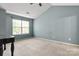 Spacious bedroom with vaulted ceiling, a window providing natural light, and an antique table at 4520 Buck Skin Ct, Fort Mill, SC 29707