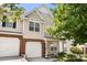 Inviting townhome exterior highlighting a brick facade and attached garage, showcasing a welcoming entrance at 4520 Buck Skin Ct, Fort Mill, SC 29707