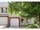 Charming townhome exterior with a brick-accented garage and lush landscaping, blending curb appeal at 4520 Buck Skin Ct, Fort Mill, SC 29707