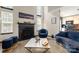 Bright living room featuring a fireplace, large windows, and stylish blue furniture at 4520 Buck Skin Ct, Fort Mill, SC 29707