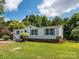 Charming home featuring a well-manicured front lawn, complemented by beautiful landscaping and mature trees at 4833 Verde View Dr, Gastonia, NC 28056