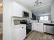 Modern kitchen featuring white cabinets, stainless steel appliances, and stylish lighting at 4833 Verde View Dr, Gastonia, NC 28056