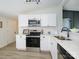 Bright kitchen with white cabinets, stainless steel appliances, and modern lighting at 4833 Verde View Dr, Gastonia, NC 28056