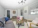 Bright living room with modern furnishings, wood floors, and an open layout looking toward kitchen at 4833 Verde View Dr, Gastonia, NC 28056