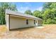 The back of house showing a concrete patio, siding, and a well-manicured lawn at 671 Sylvan Sw St, Concord, NC 28025