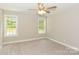 Bright bedroom with plush carpet, neutral color palette, and natural light from two windows, creating a peaceful retreat at 671 Sylvan Sw St, Concord, NC 28025