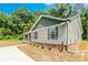 Well-maintained home exterior with gray siding, complementary trim, and lush greenery at 671 Sylvan Sw St, Concord, NC 28025