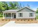 Charming single-story home featuring horizontal siding, complementary color accents, and a well-maintained landscape at 671 Sylvan Sw St, Concord, NC 28025