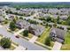 Aerial view of two-story home featuring an attached garage and landscaped front yard at 7362 Waterwheel Sw St, Concord, NC 28025