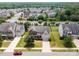 Aerial view of the home featuring mature landscaping, a driveway, and a lush, green lawn at 7362 Waterwheel Sw St, Concord, NC 28025