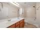 Well-lit bathroom featuring a double sink vanity, tile floors, and a shower and tub combo at 7362 Waterwheel Sw St, Concord, NC 28025