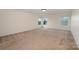 Large bedroom featuring neutral carpet, large windows, and abundant natural light at 7362 Waterwheel Sw St, Concord, NC 28025