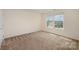 Bedroom with neutral walls, carpet floors, two windows with blinds, and a closet at 7362 Waterwheel Sw St, Concord, NC 28025