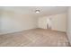 Large bedroom featuring neutral carpet, ample space, and abundant natural light at 7362 Waterwheel Sw St, Concord, NC 28025