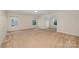 Spacious bonus room features neutral carpet, ample natural light from three windows, and a unique architectural alcove at 7362 Waterwheel Sw St, Concord, NC 28025