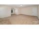 Neutral bonus room with neutral walls, plush carpet, recessed lighting, and an attached room with arched entry at 7362 Waterwheel Sw St, Concord, NC 28025
