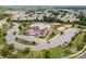 Aerial view of a community pool, clubhouse, playground, and parking lot at 7362 Waterwheel Sw St, Concord, NC 28025