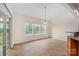 Sunlit dining area with tile floors, leading to a screened porch, and granite breakfast bar with pendant light fixture at 7362 Waterwheel Sw St, Concord, NC 28025