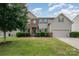 Charming two-story home featuring a brick and siding facade, manicured lawn, and attached two-car garage at 7362 Waterwheel Sw St, Concord, NC 28025