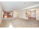 Inviting living room with carpeted floors and an open layout adjacent to kitchen and a staircase to the second floor at 7362 Waterwheel Sw St, Concord, NC 28025