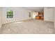Open living room with neutral carpet, view into the kitchen, and bright natural light at 7362 Waterwheel Sw St, Concord, NC 28025