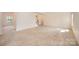 Spacious living area with neutral carpet, large windows, and access to the upstairs at 7362 Waterwheel Sw St, Concord, NC 28025