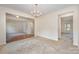 Open-concept living space with neutral carpet, access to other rooms, and natural light at 7362 Waterwheel Sw St, Concord, NC 28025
