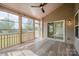 Enclosed porch with vaulted ceiling, wood-look flooring, and views of the backyard for relaxation and entertainment at 7362 Waterwheel Sw St, Concord, NC 28025