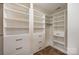Custom walk-in closet with built in shelving and drawers for ample storage at 7362 Waterwheel Sw St, Concord, NC 28025