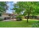 A verdant backyard features a brick patio and well-maintained lawn at 810 Lakeview Dr, Pineville, NC 28134
