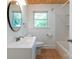 Well-lit bathroom with a large, modern sink, updated fixtures, and a shower/tub combo at 810 Lakeview Dr, Pineville, NC 28134