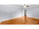 Spacious bedroom with hardwood floors, ceiling fan, and neutral paint scheme at 810 Lakeview Dr, Pineville, NC 28134